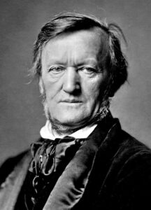 Richard Wagner in einer Porträtaufnahme um 1871, mit markantem Seitenblick, Barett und dunklem Samtjackett, fotografiert in Bayreuth.
