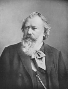 Johannes Brahms mit seinem charakteristischen Bart, eine Fotografie aus seinen späten Wiener Jahren um 1890, die den Komponisten nachdenklich zeigt.