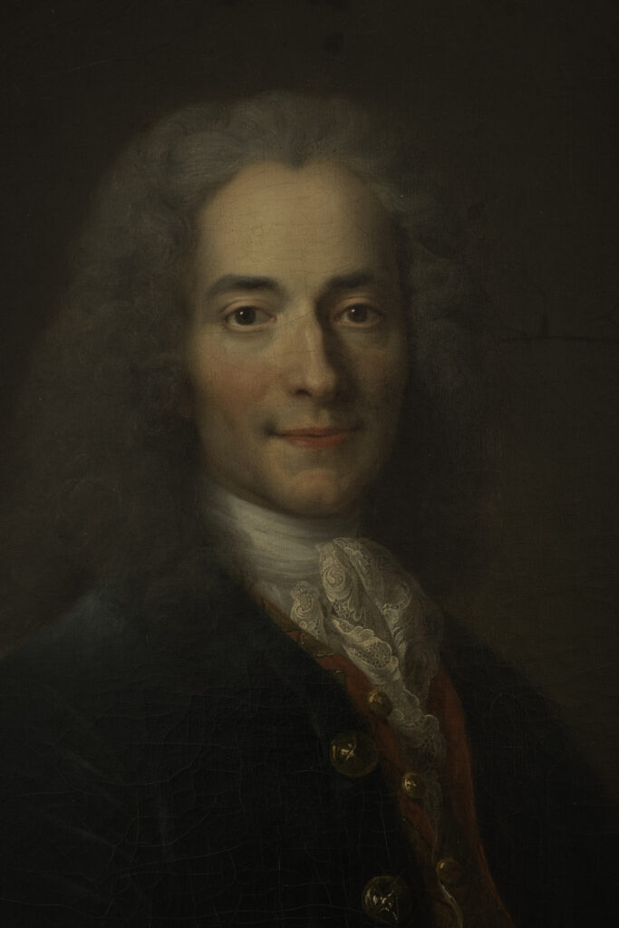 Marmorbüste von Voltaire, gefertigt von Jean-Antoine Houdon, die den alternden Denker mit einem scharfen und ironischen Blick zeigt.