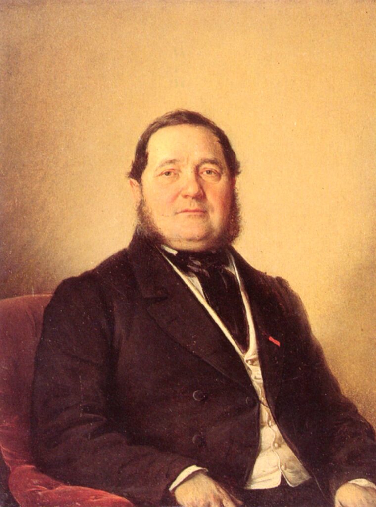 Adalbert Stifter in einer Fotografie um 1860, sitzend in einem Stuhl, mit nachdenklichem Blick und markantem Bart, typisch für das 19. Jahrhundert.